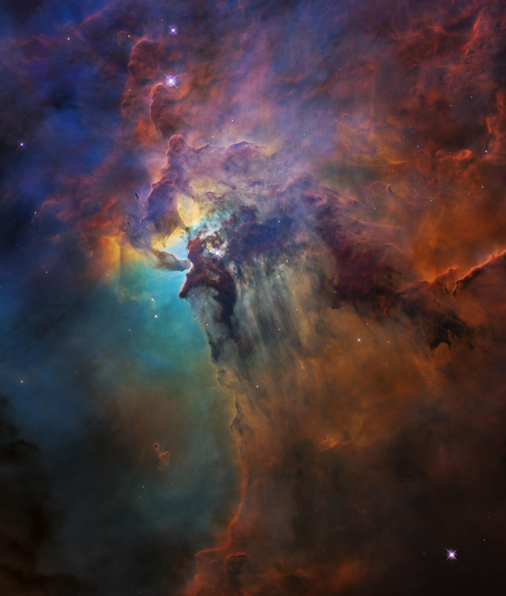 Hubble's View of the Lagoon Nebula A vibrant visible-light image from the Hubble Space Telescope showing the heart of the Lagoon Nebula. A fantasy landscape of ridges, cavities, and mountains of glowing gas and dust is sculpted by intense radiation from the monster young star, Herschel 36,